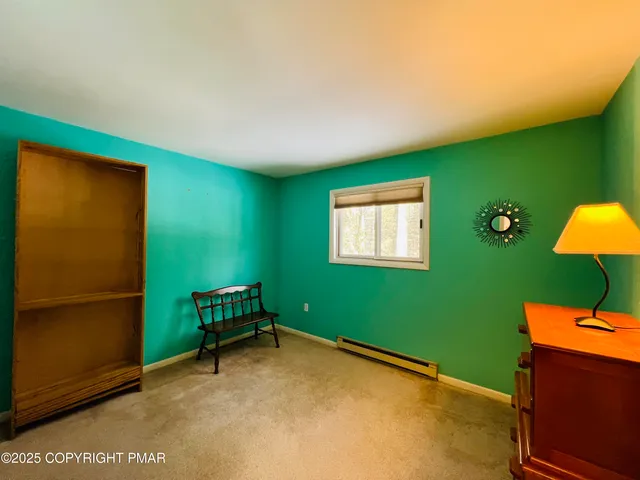 a view of a room with a projector and windows