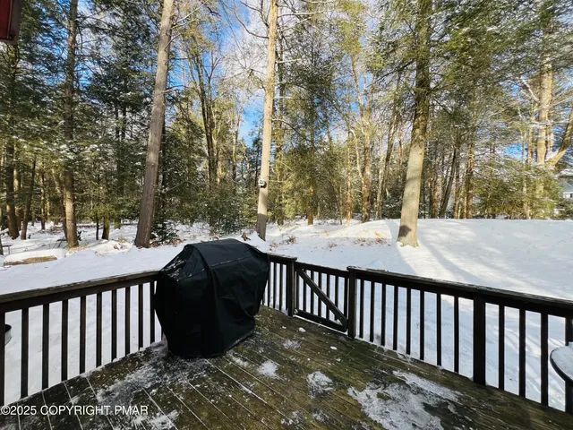 a view of a wooden bench on the roof deck