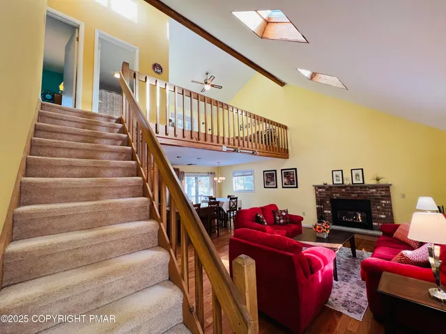 a living room with furniture or stairs and a fireplace