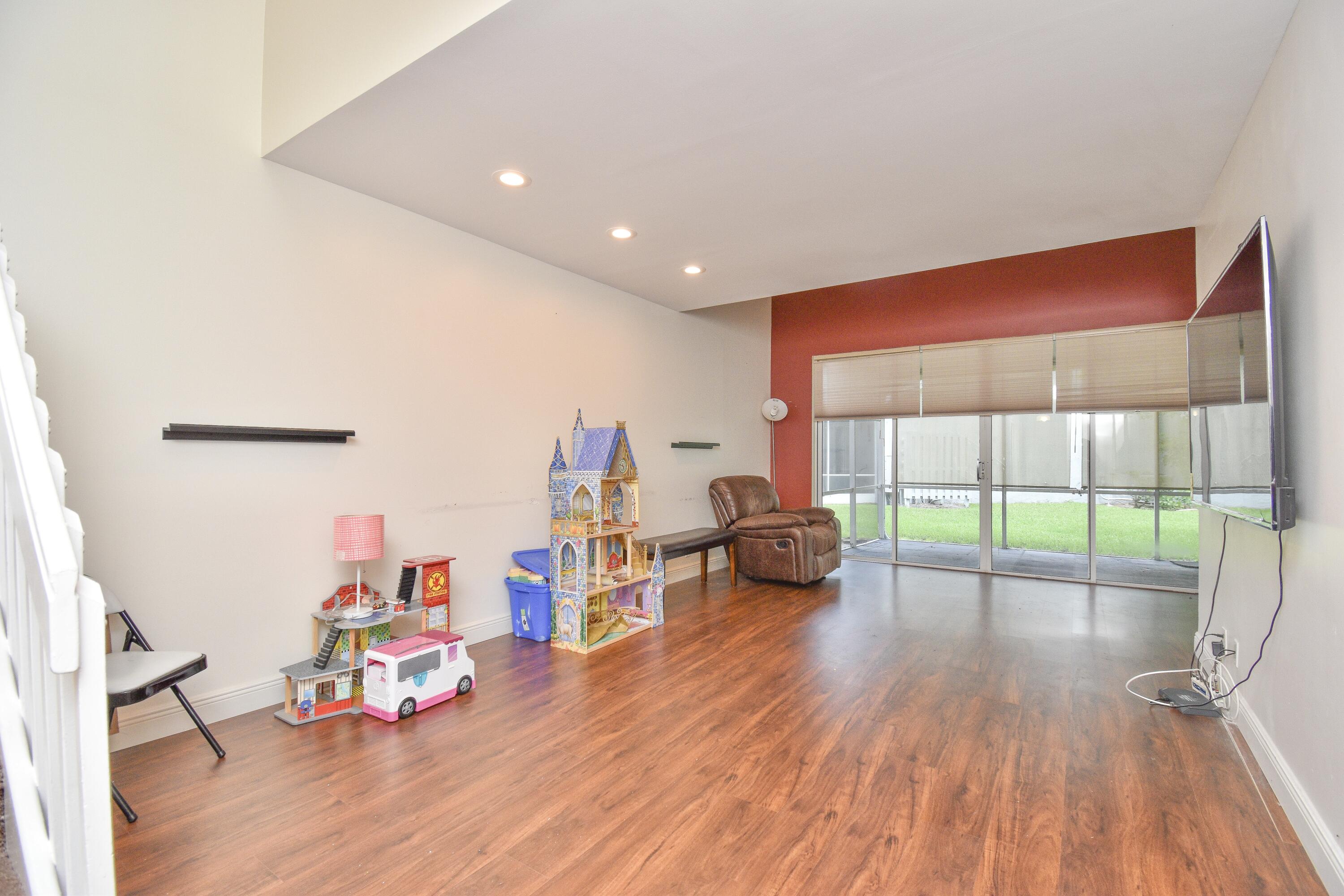 6053 Old Court Road, Unit 308 Boca Raton, FL 33433 - Photo 8 of 22 a view of a livingroom with furniture wooden floor and a floor to ceiling window
