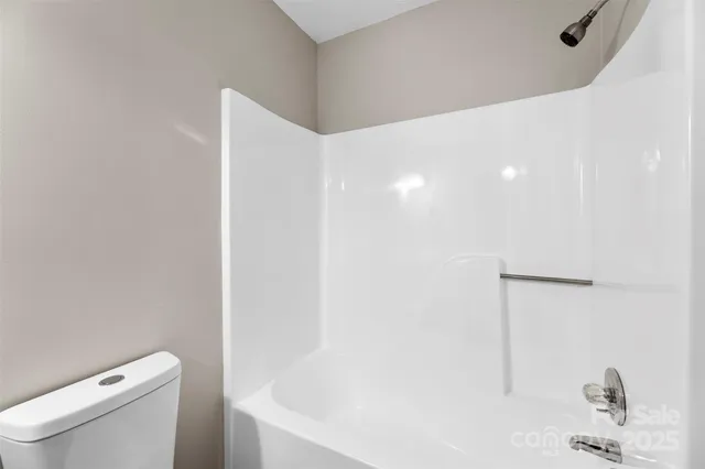 a view of room with wooden floor and fan