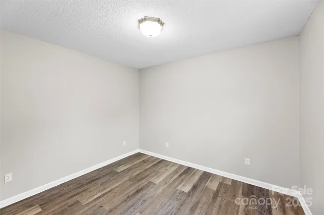 a view of an empty room and wooden floor