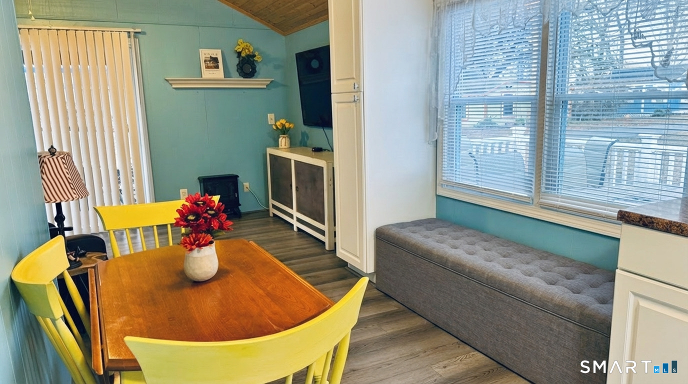 16 North Street Madison, CT 06443 - Photo 14 of 25 Dining area with cushioned bench - There is storage under the bench