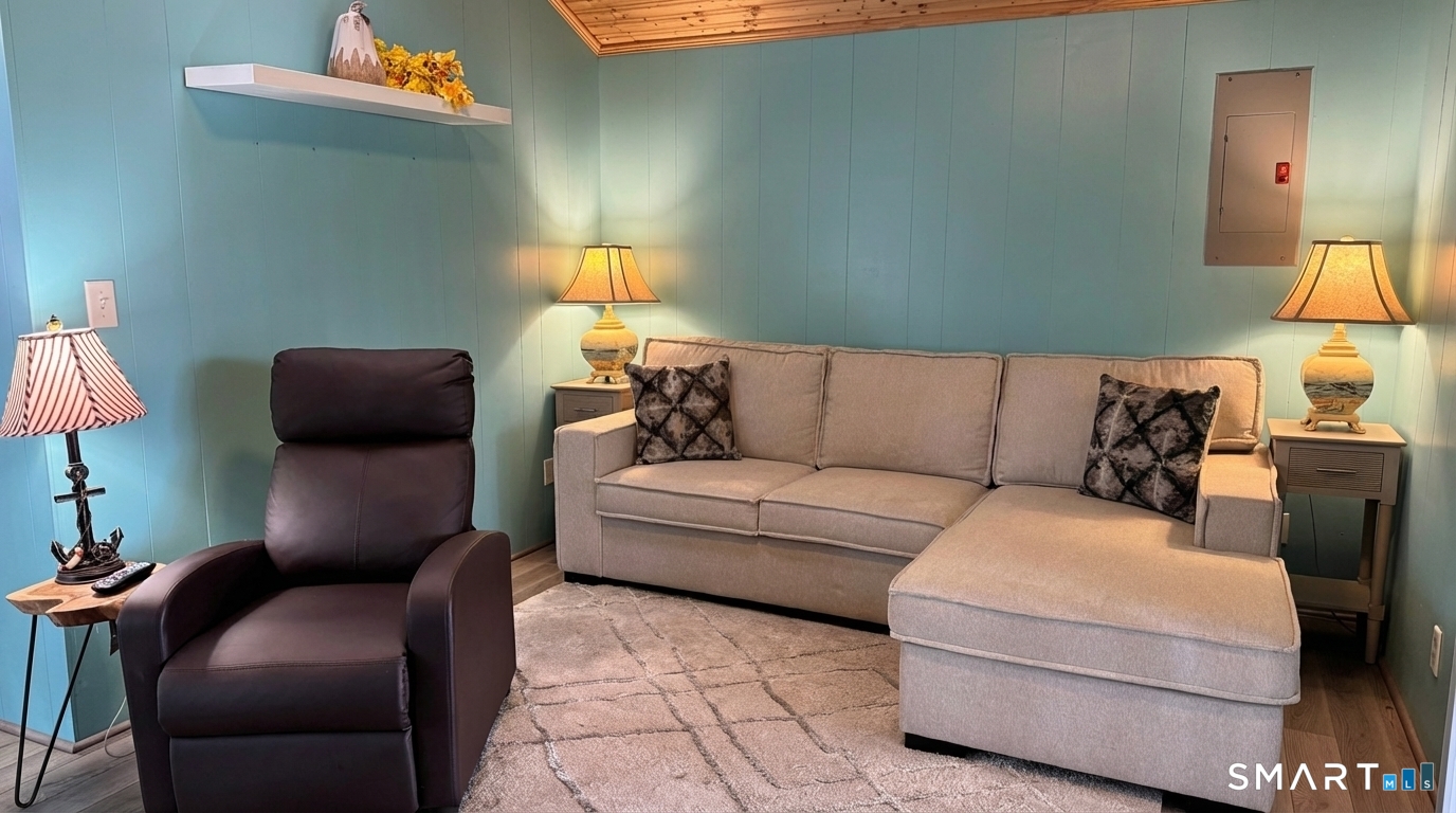 16 North Street Madison, CT 06443 - Photo 19 of 25 Living room with convertible couch and recliner