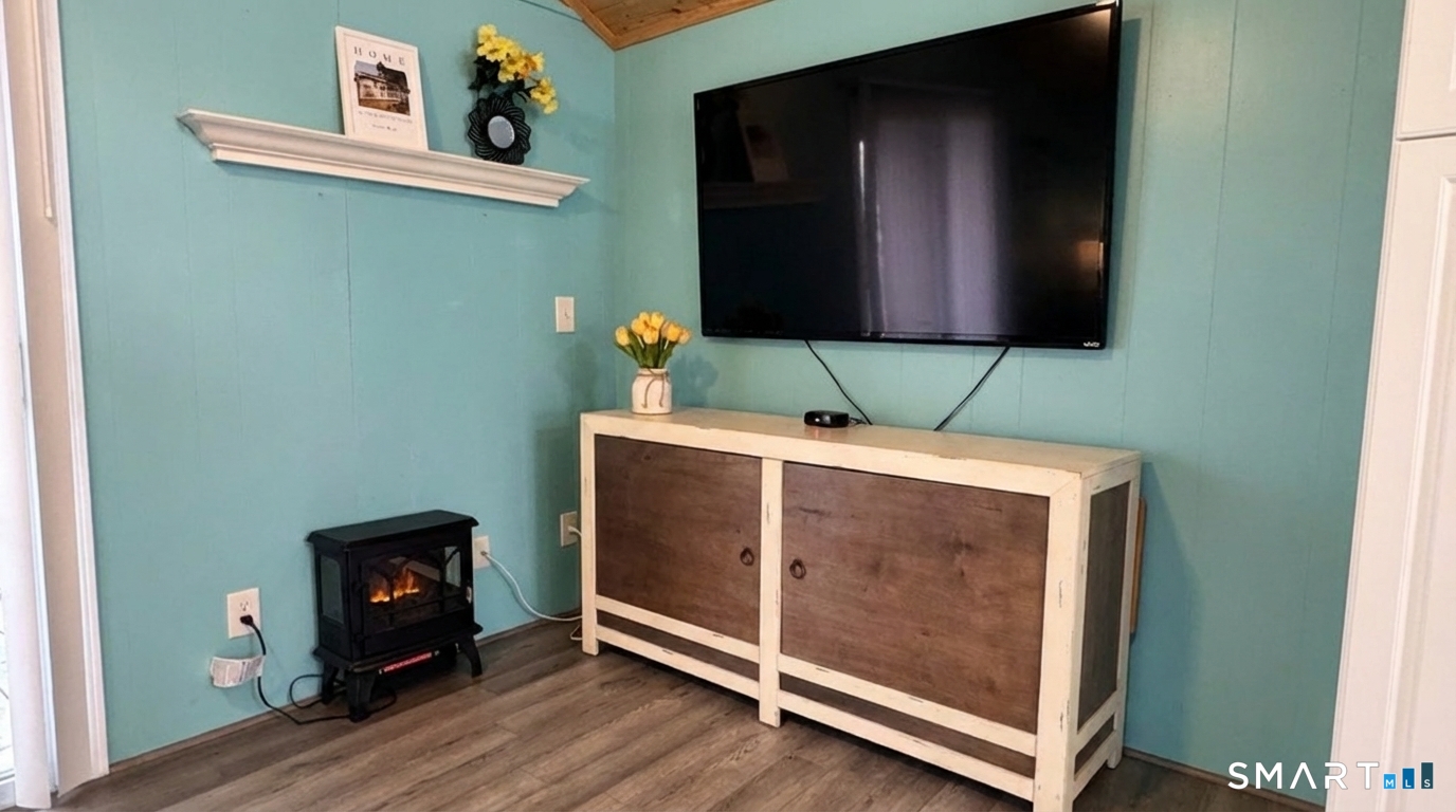 16 North Street Madison, CT 06443 - Photo 20 of 25 Storage cabinet, TV and Electric Heater included