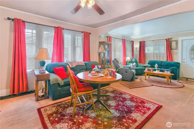 a living room with furniture a rug and a chandelier