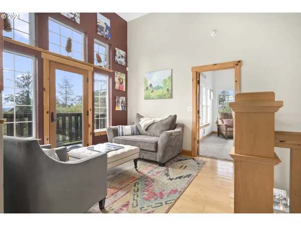 a living room with furniture and a floor to ceiling window