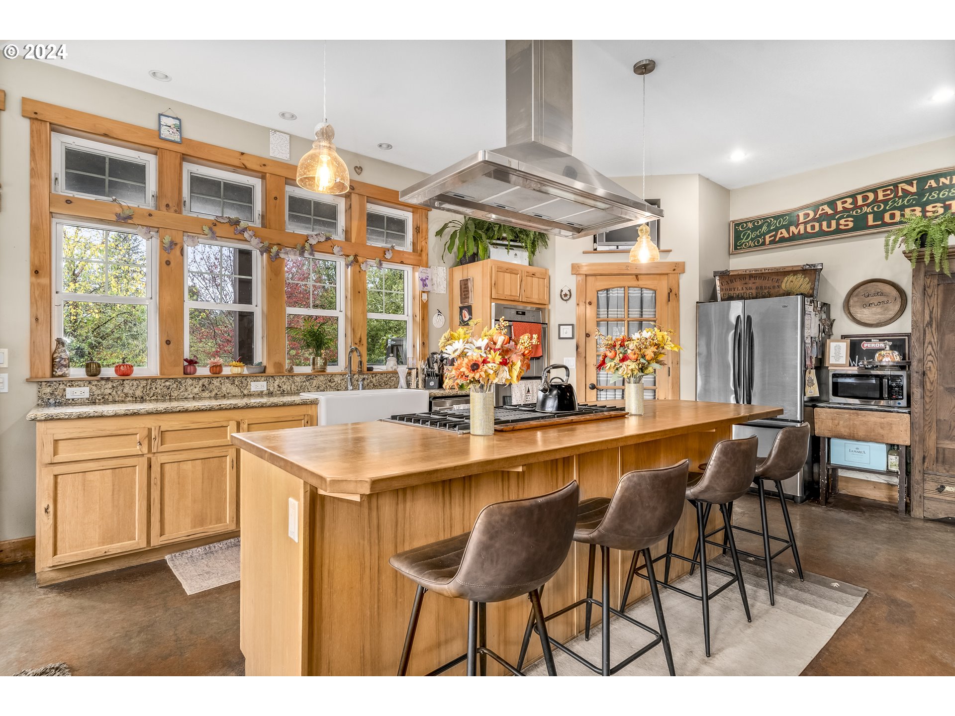 4701 Northeast Neotsu Drive Neotsu, OR 97364 - Photo 5 of 46 a kitchen with stainless steel appliances granite countertop a table chairs and a large window