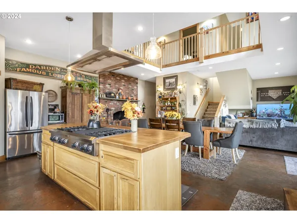 a dining room with furniture a book shelves and wooden floor