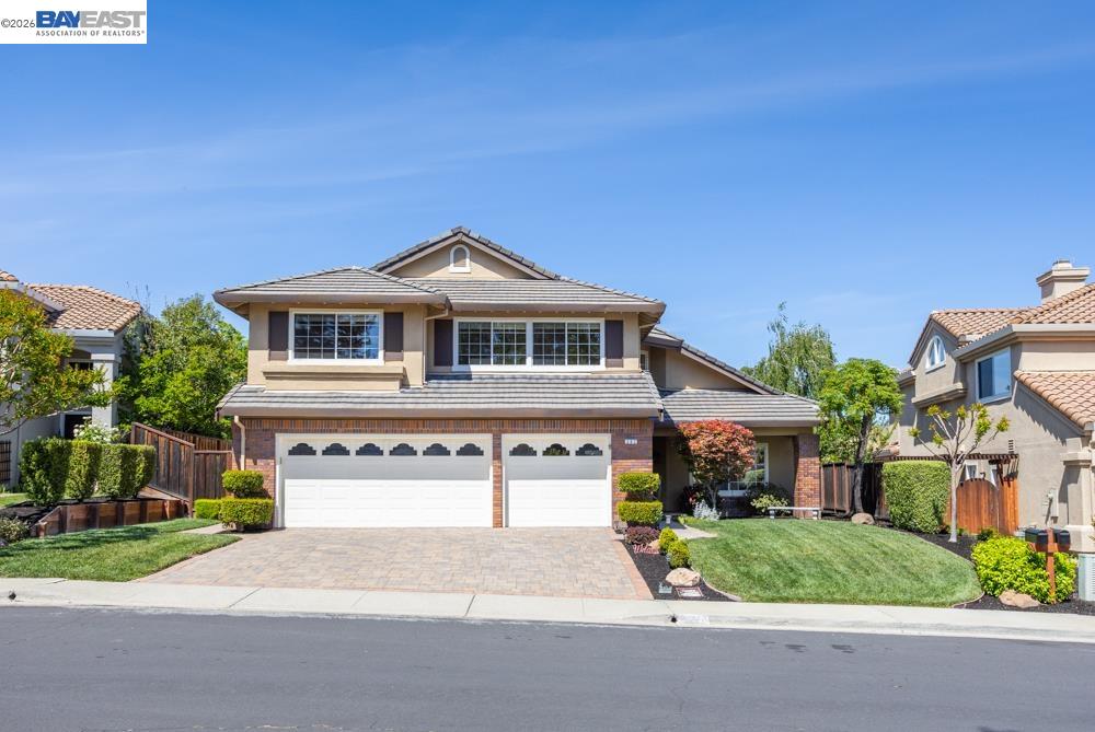 a front view of a house with a yard and garage