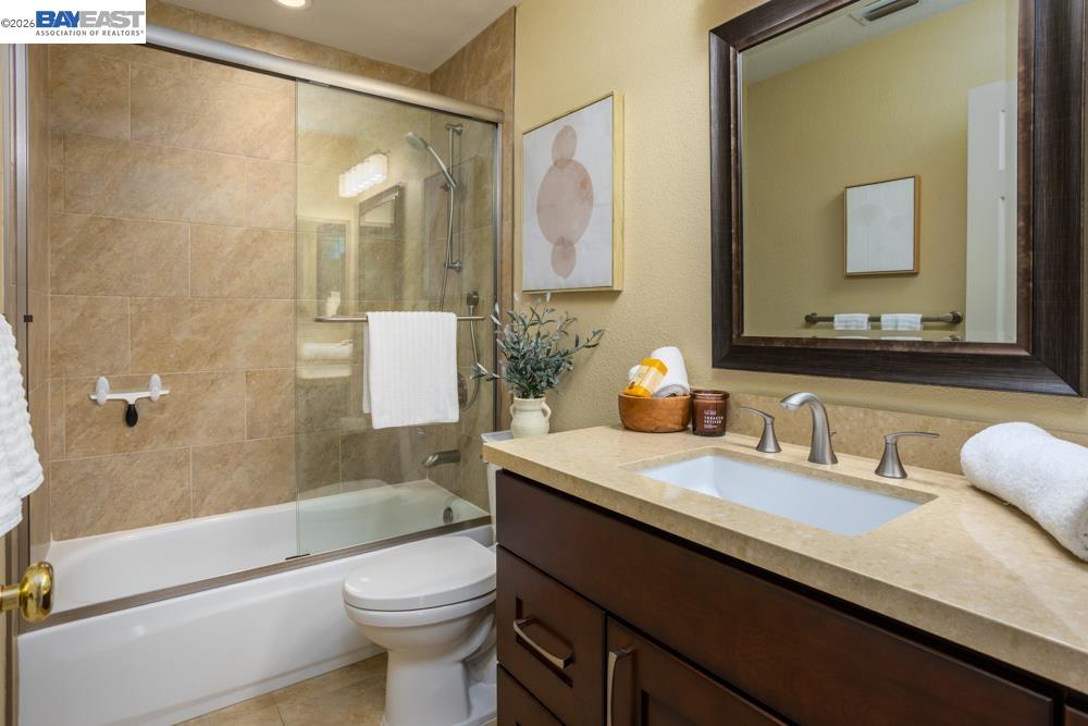 302 Sunset Drive Danville, CA 94506 - Photo 13 of 31 a bathroom with a granite countertop sink toilet and shower