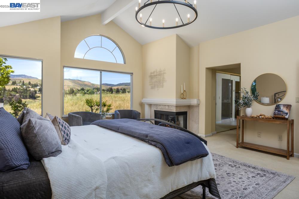 302 Sunset Drive Danville, CA 94506 - Photo 17 of 31 a bedroom with a bed and a chandelier