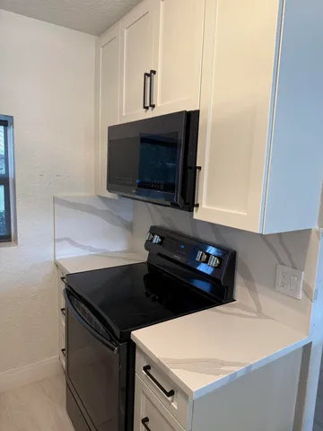 a kitchen with a stove and a microwave