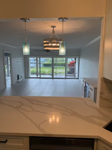 a view of a room with a ceiling fan