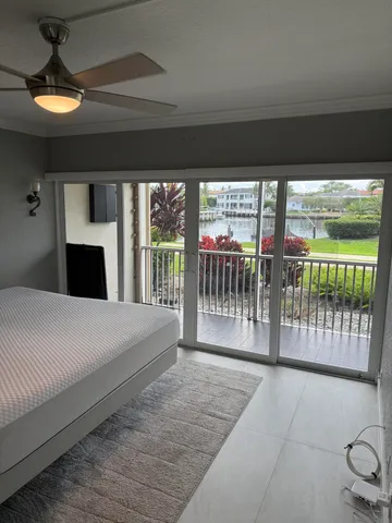 a bedroom with a large bed and a large window