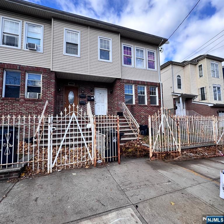 a front view of a house with a fence