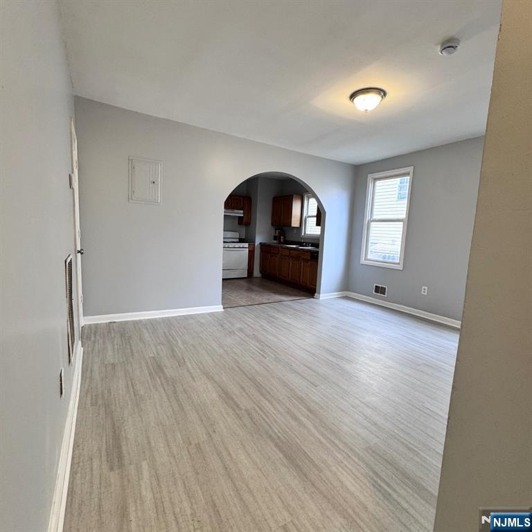 97 Clinton Place Newark, NJ 07108 - Photo 3 of 9 an empty room with wooden floor and a window