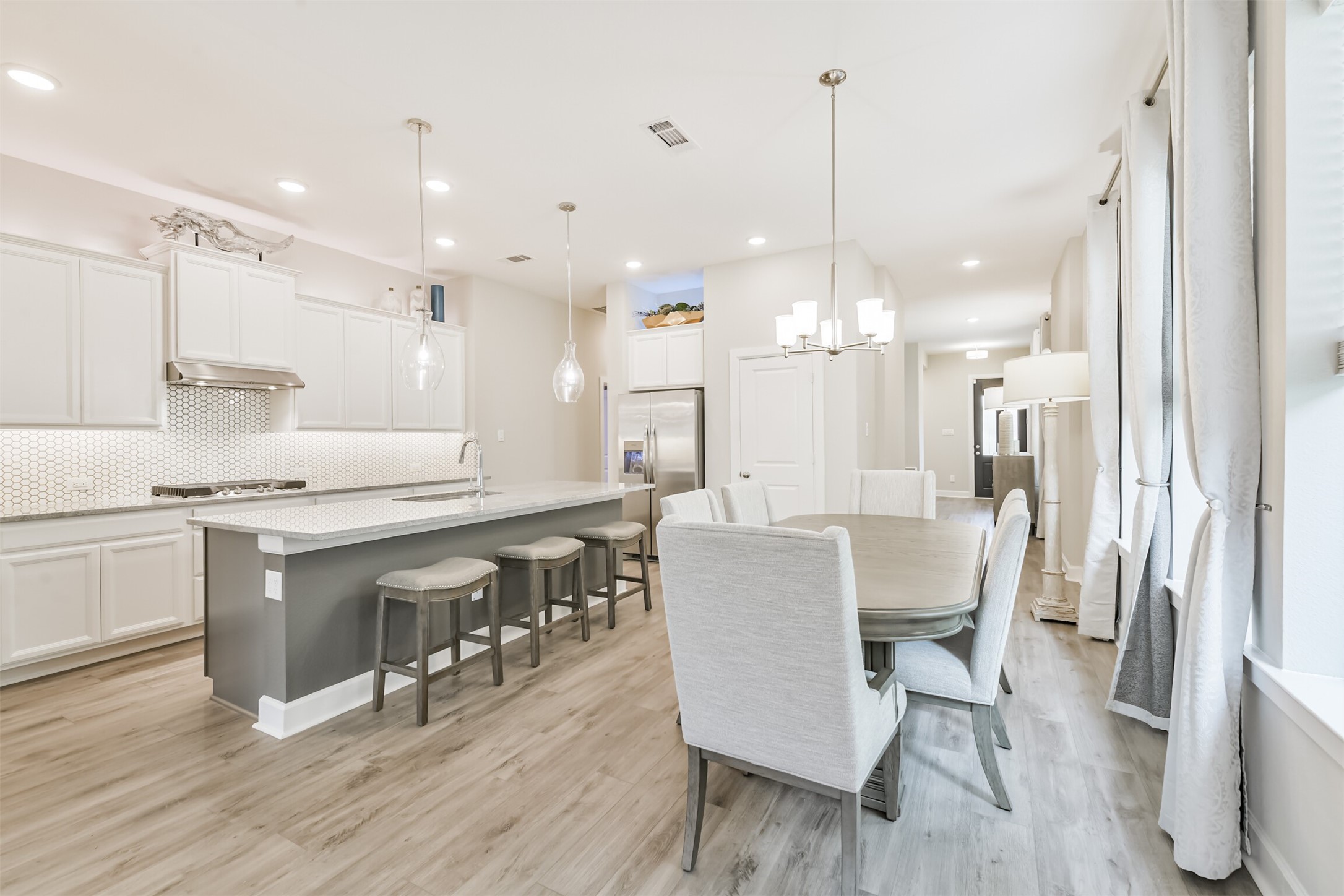 15611 Rising Wren Court Conroe, TX 77302 - Photo 12 of 38 a large kitchen with a table and chairs