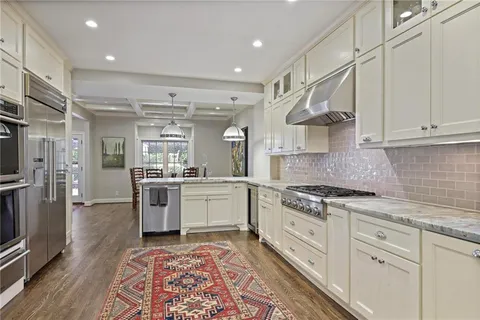 a kitchen with stainless steel appliances and refrigerator