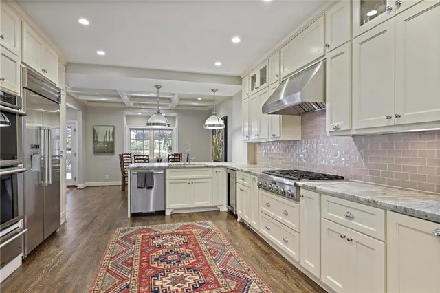 a kitchen with stainless steel appliances and refrigerator