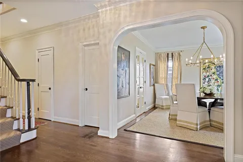 a view of hall way with furniture and closet
