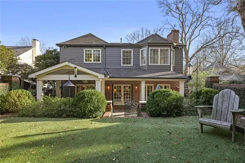 a aerial view of a house with a yard and potted plants