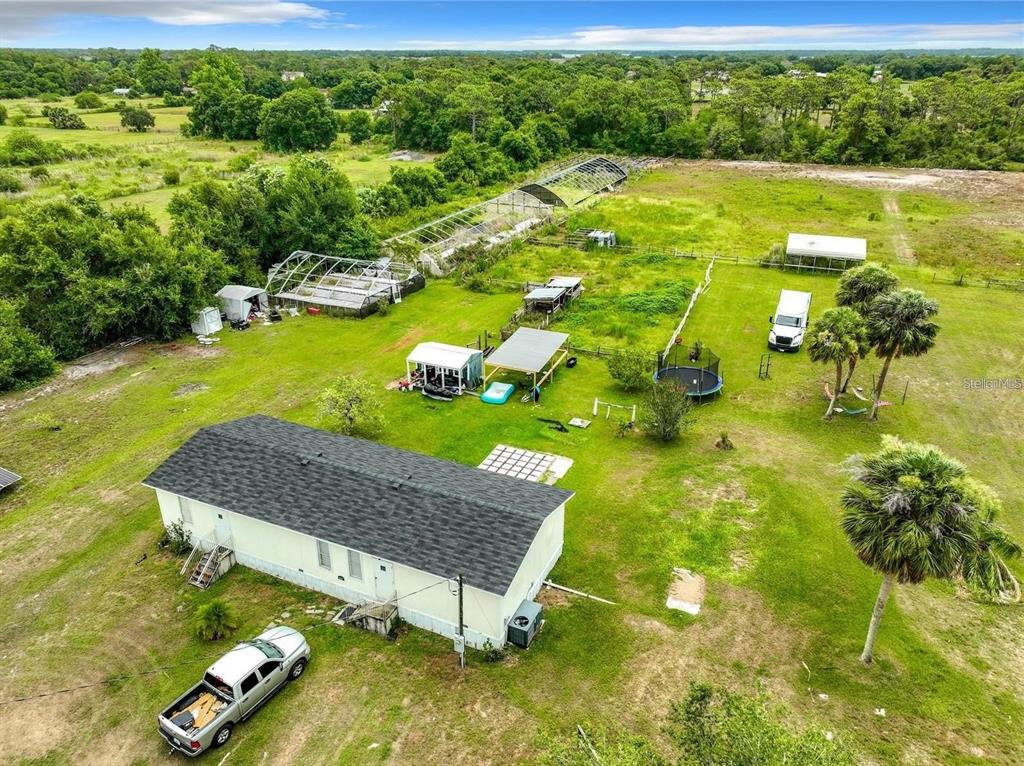 3345 Rambler Avenue St. Cloud, FL 34772 - Photo 2 of 7 a view of an ocean pool and trees in the background
