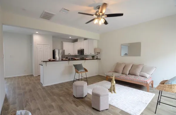 a living room with furniture and kitchen view