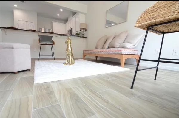 a living room with furniture and a wooden floor