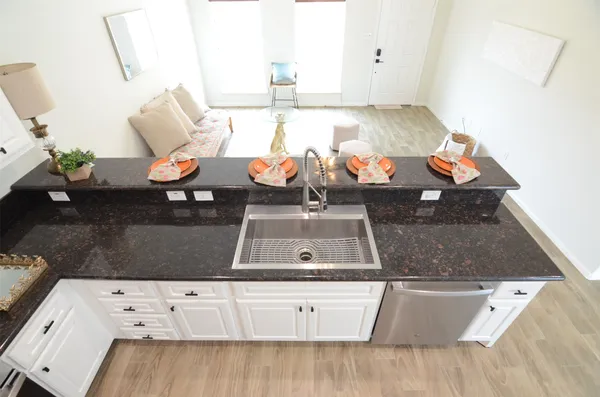 a view of living room with furniture and wooden floor