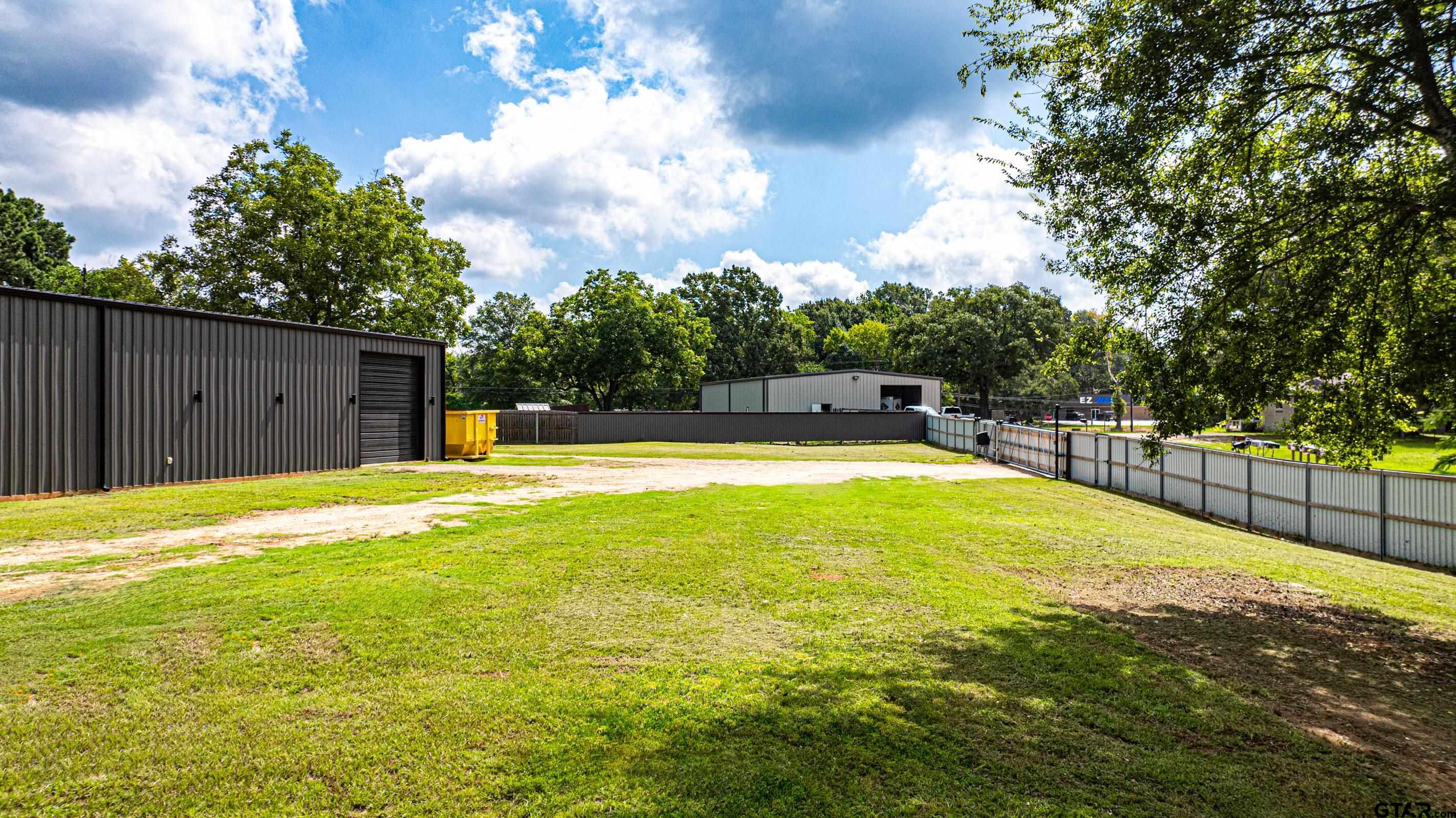 126 Gamel Road Longview, TX 75604 - Photo 16 of 23 a swimming pool with an outdoor seating and house in the background