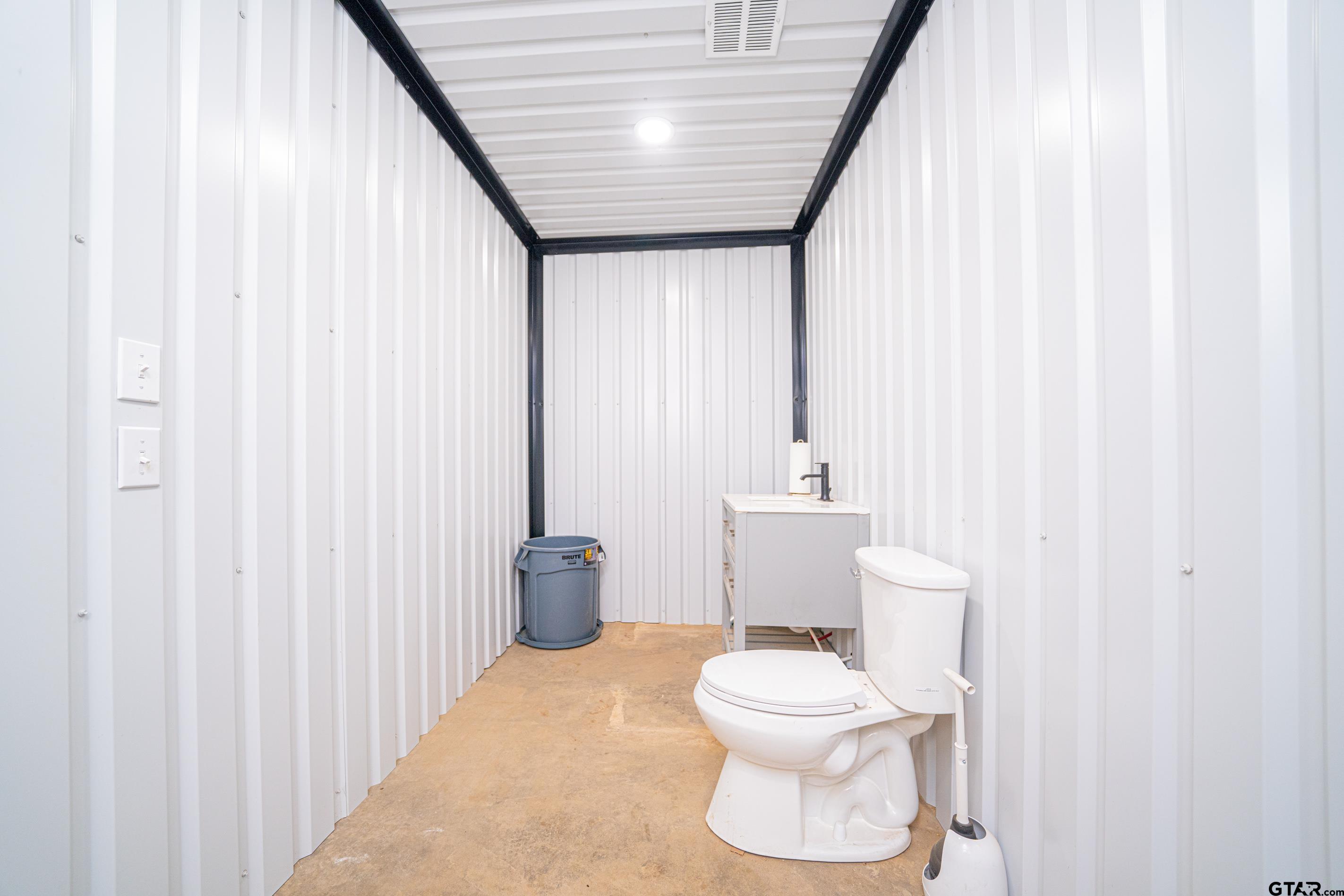 126 Gamel Road Longview, TX 75604 - Photo 18 of 23 a white toilet sitting next to a shower curtain