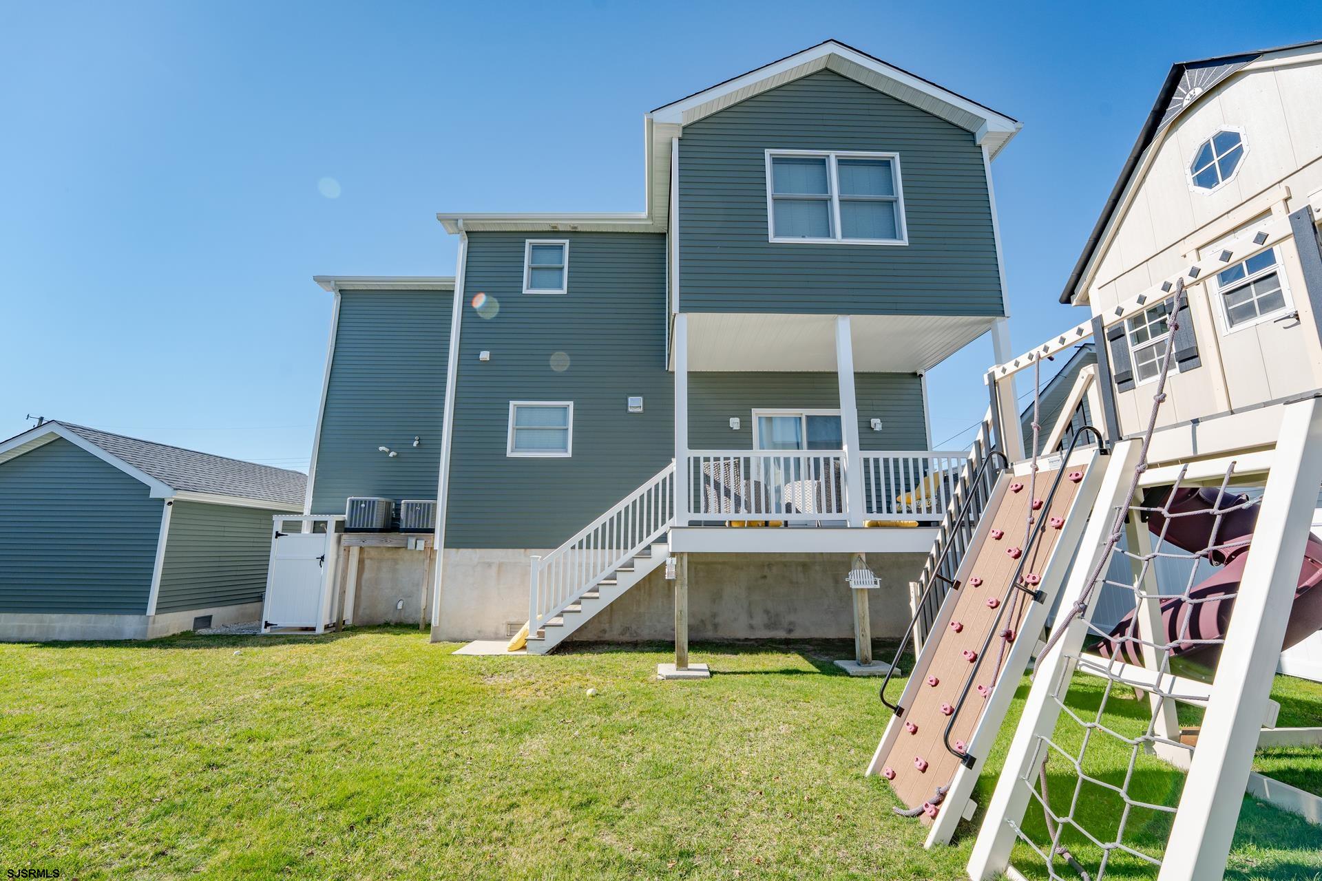 703 Bobby Jones Road Brigantine, NJ 08203 - Photo 27 of 34 a view of an house with backyard and deck