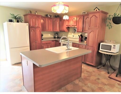 194 Root Road Barre, MA 01005 - Photo 3 of 25 a kitchen with sink a refrigerator and chairs
