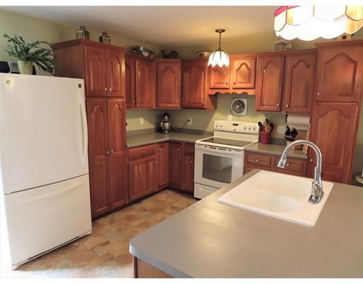 194 Root Road Barre, MA 01005 - Photo 4 of 25 a kitchen with cabinets a stove and a refrigerator