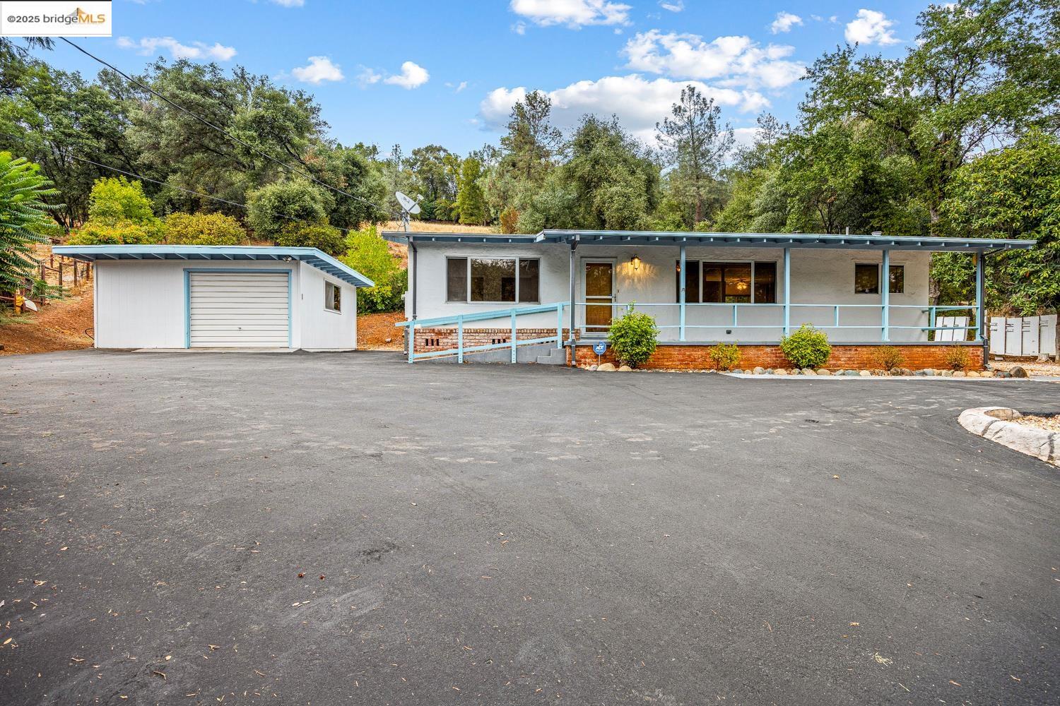 a view of a house with pool and a yard