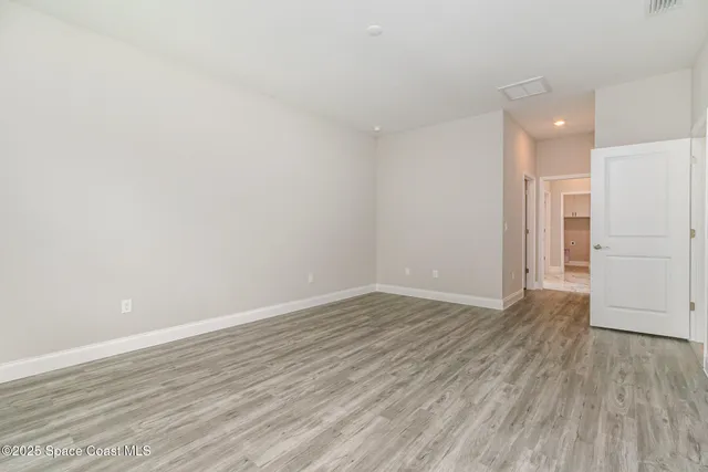 a kitchen with stainless steel appliances granite countertop a sink a stove a refrigerator a microwave a sink and cabinets