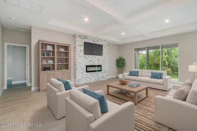 a view of empty room with wooden floor and fireplace