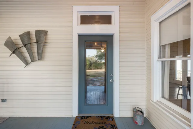 a hallway with windows and cabinet