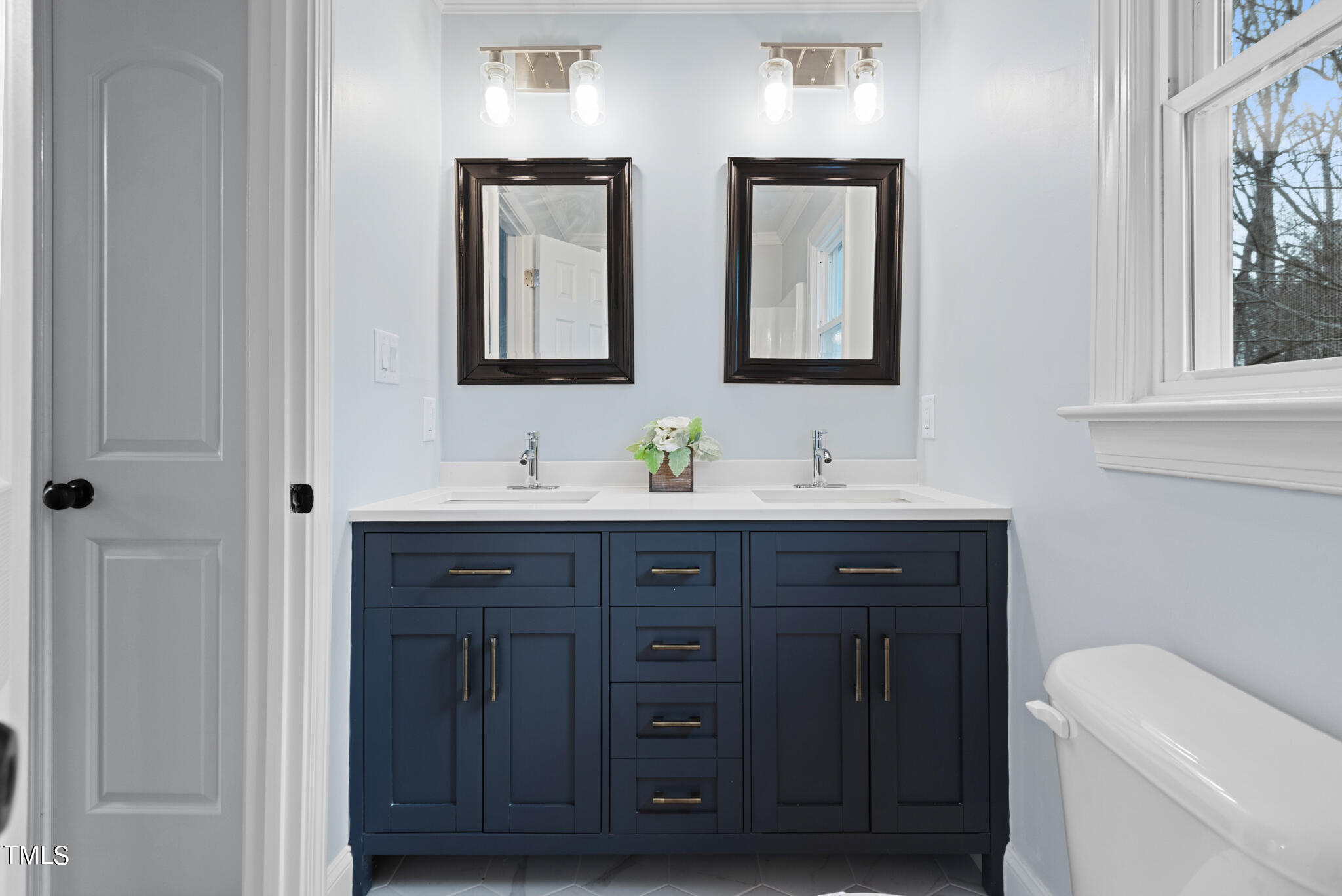 3012 Old Crews Road Raleigh, NC 27616 - Photo 16 of 34 a bathroom with a double vanity sink and a mirror