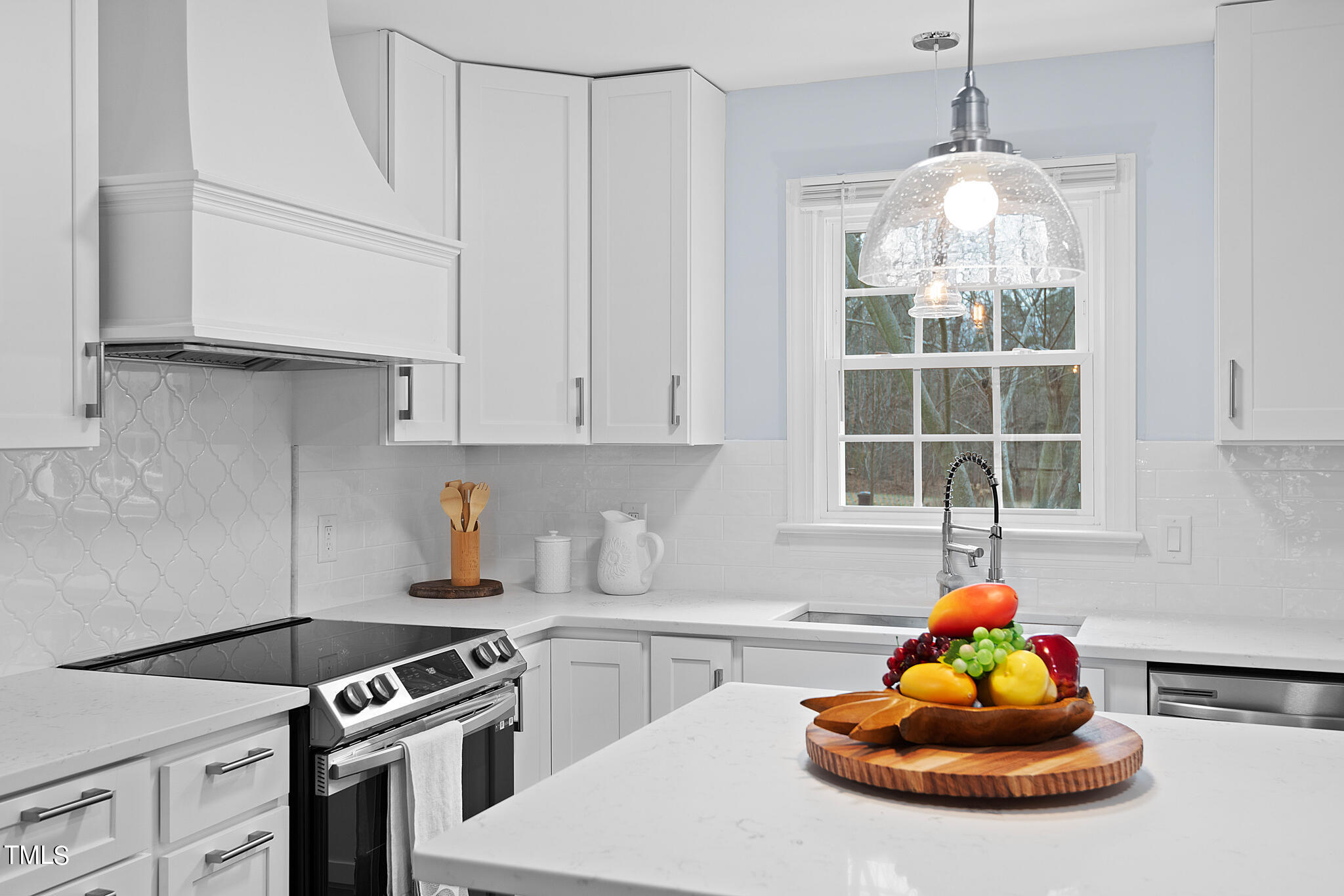 3012 Old Crews Road Raleigh, NC 27616 - Photo 10 of 34 a kitchen with a sink a stove and cabinets