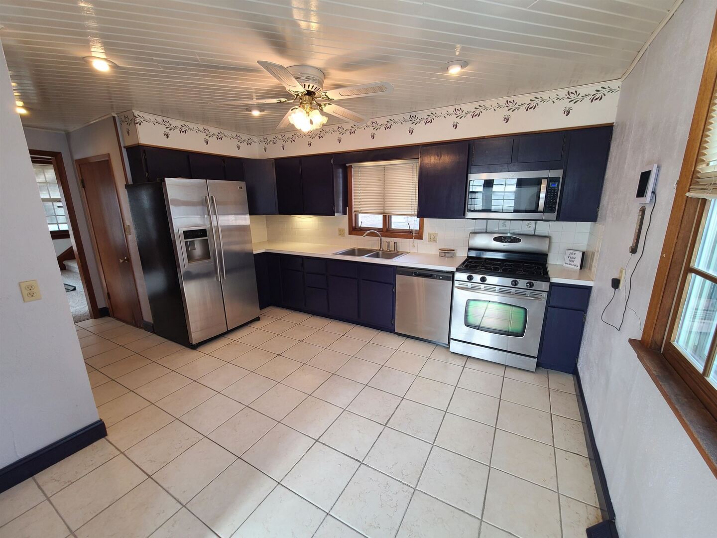 423 South Grove Street Walcott, IA 52773 - Photo 11 of 30 a room with stainless steel appliances kitchen island granite countertop a refrigerator and a stove top oven