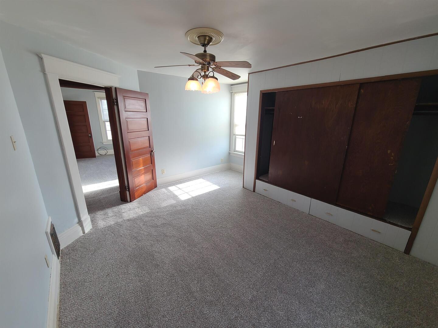 423 South Grove Street Walcott, IA 52773 - Photo 22 of 30 a view of a livingroom with a ceiling fan and window