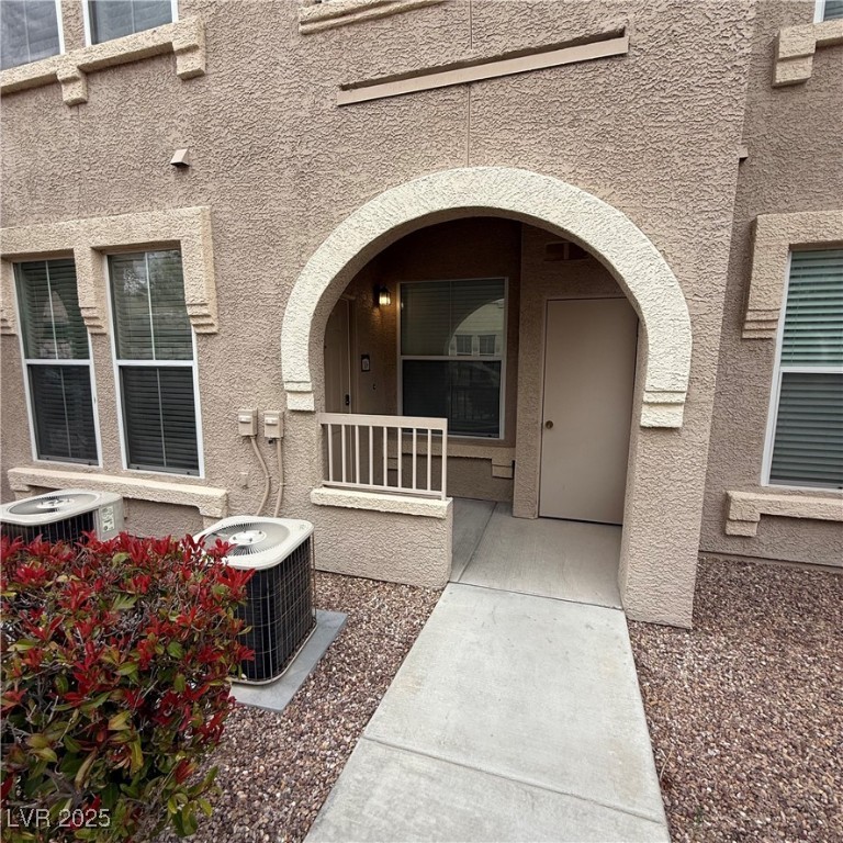 10550 West Alexander Road, Unit 1106 Las Vegas, NV 89129 - Photo 1 of 18 View of exterior entry featuring central air condi