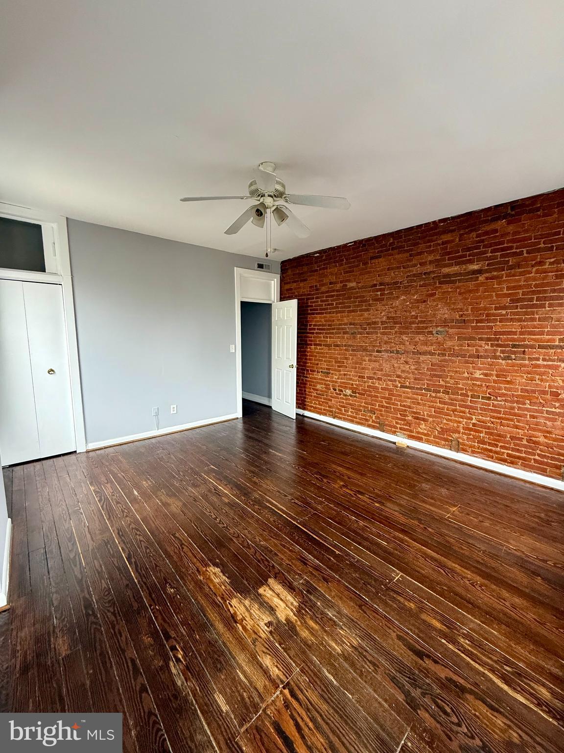 1001 Light Street, Unit 3 Baltimore, MD 21230 - Photo 7 of 14 a view of an empty room with wooden floor and a window