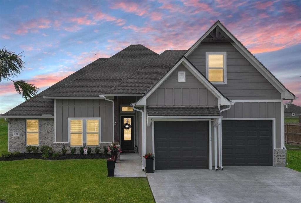 a front view of a house with a yard and garage