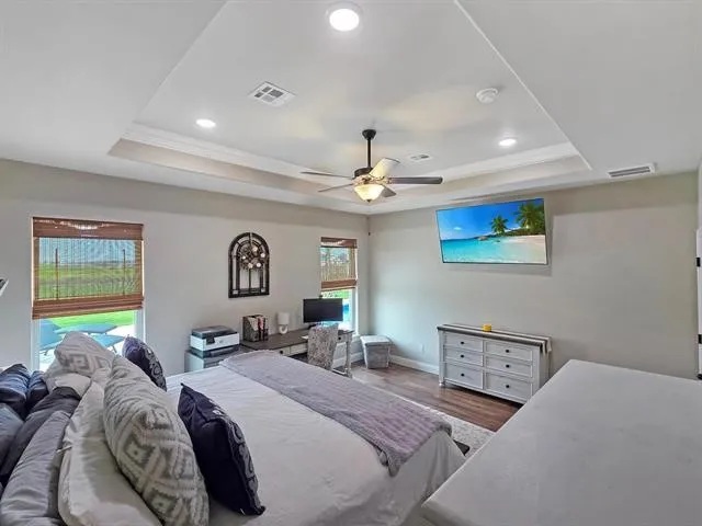 a bedroom with a bed and a ceiling fan