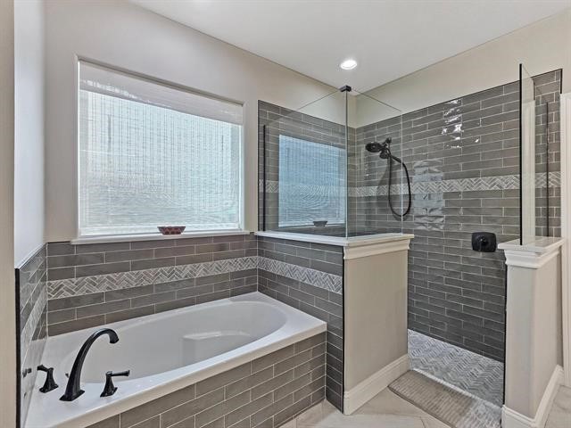 14845 Norma Jane Lane Beaumont, TX 77713 - Photo 16 of 35 a bathroom with a bathtub and a shower