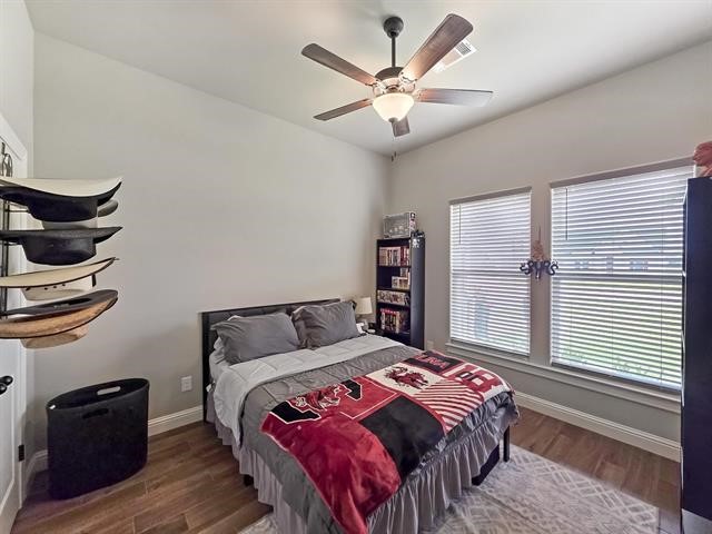 14845 Norma Jane Lane Beaumont, TX 77713 - Photo 18 of 35 a bedroom with a large bed and a large window