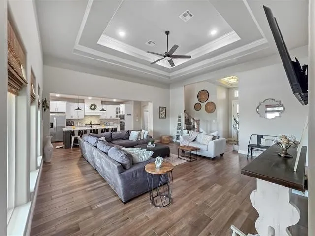 a living room with fireplace furniture and a wooden floor